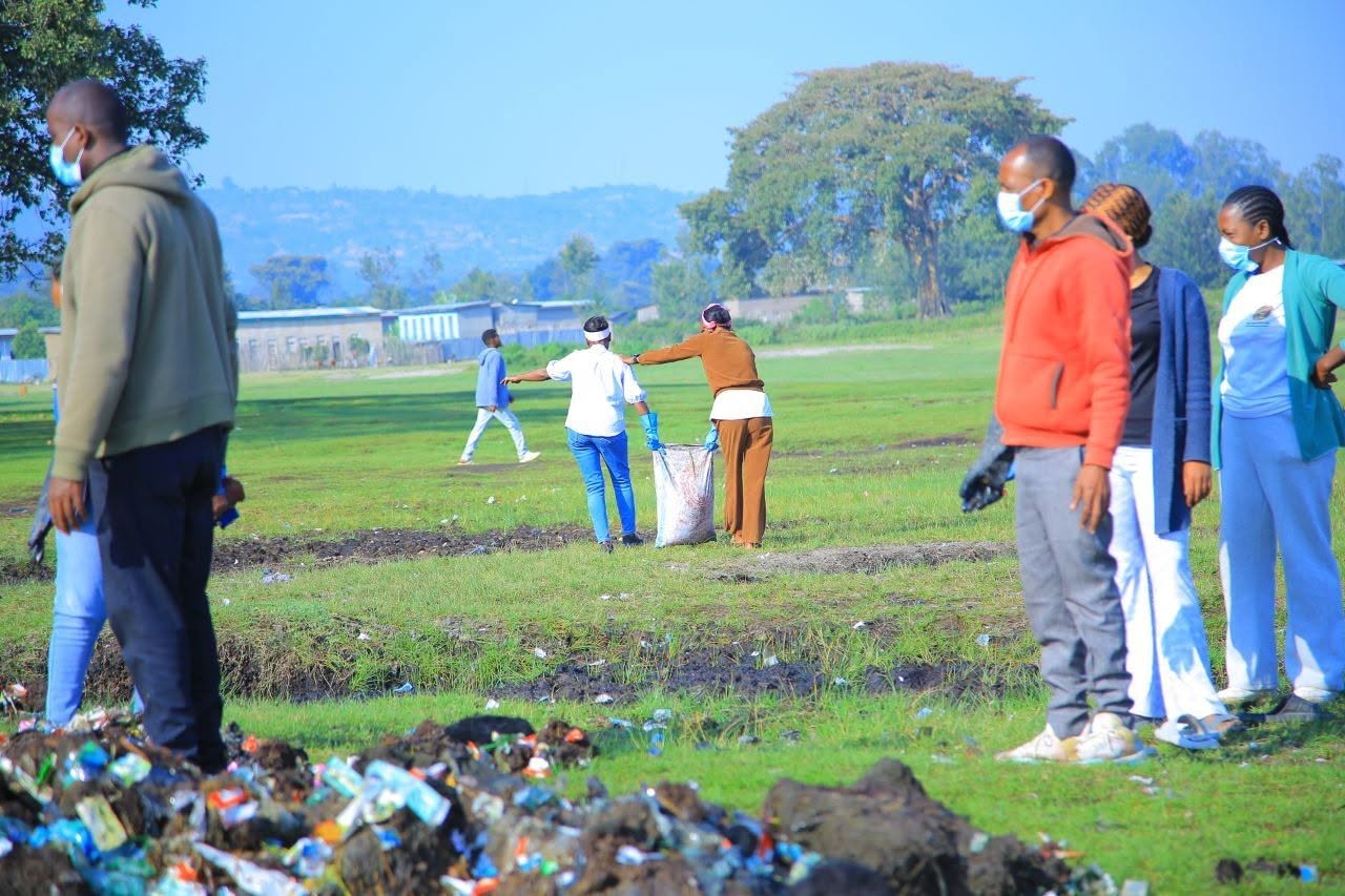 Volunteers collecting plastic waste in a field